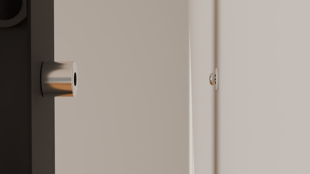 Stainless standoff on the back of an upright lining up with the screw head