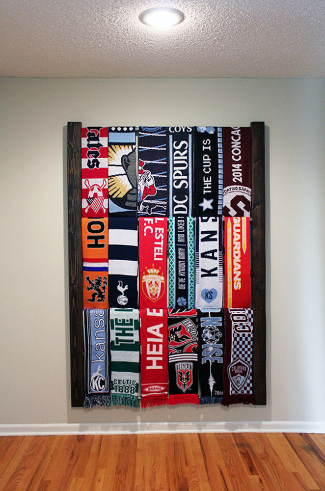 Bernabeu Soccer Scarf Display Rack: Wooden rack with neatly arranged scarves.